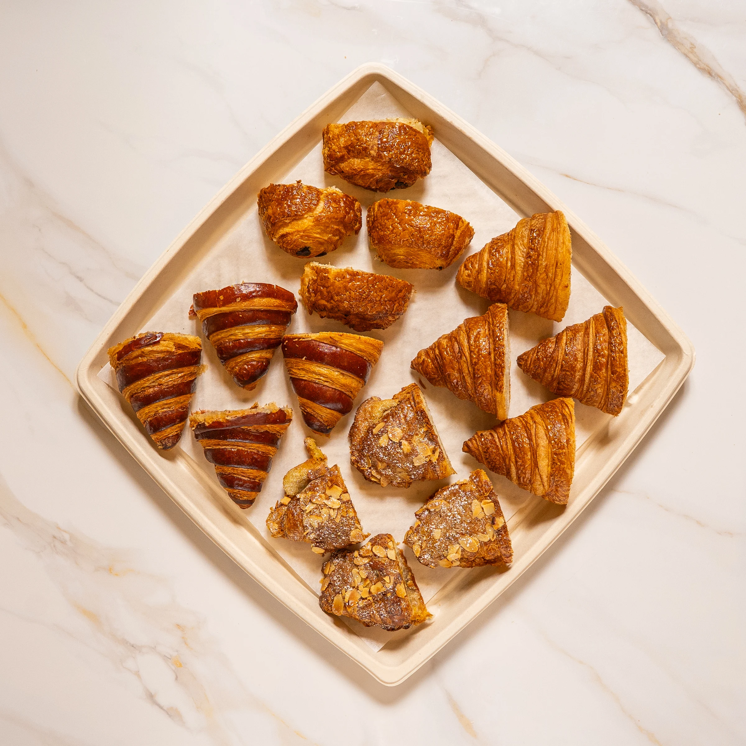 Assorted French pastry platter from Madame Olivia with croissants, pain au chocolat, and almond croissants