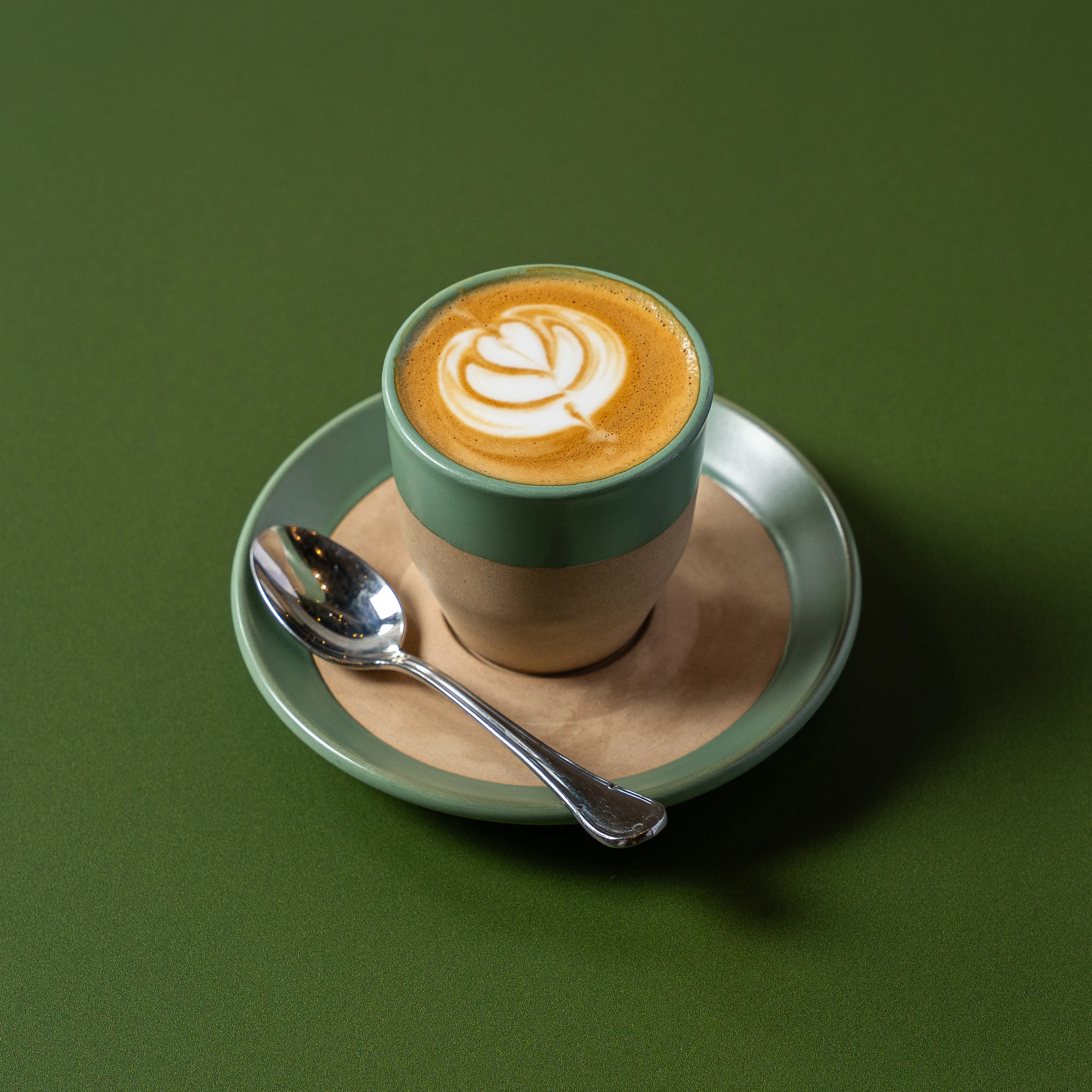 Cortado with rosetta latte art and spoon at Madame Olivia